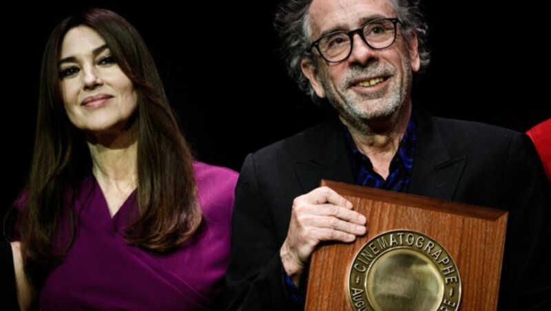 An diesem Tag hat es gefunkt! US-Regisseur Tim Burton bekam am 21. Oktober 2022 von Monica Bellucci während des Lumiere Film Festivals in Lyon den Lumiere Award überreicht und verliebte sich in die Schauspielerin - und sie in ihn. (Bild: APA/Photo by JEFF PACHOUD/AFP)