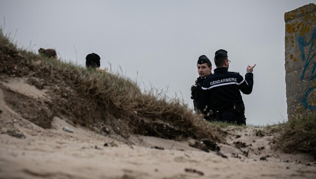 Gendarmen der Hundestaffel „Cynophile“ patrouillieren am Strand der Batterie Blankenese in Neville sur Mer, Nordwestfrankreich. Die bisher angeschwemmten Drogen haben einen geschätzten Verkaufswert von fast 150 Millionen Euro. (Bild: AFP/Lou BENOIST)