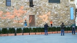 Eine Klimaaktivistin sprüht Farbe auf den Palazzo Vecchio in Florenz. (Bild: Screenshot Twitter/L‘ultima generazione)