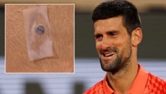 Novak Djokovic sorgt mit einer kleinen Metallscheibe auf der Brust einmal mehr für viel Gesprächsstoff. (Bild: APA/AFP/Thomas SAMSON/Twitter.com/TheTennisLetter/krone.at-kreativ)