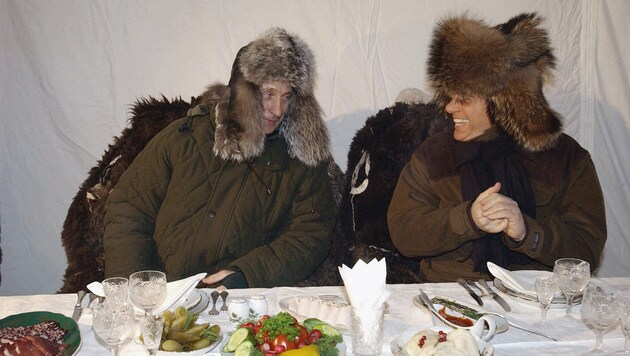 Putin und Berlusconi im Jahr 2003 beim gemütlichen Beisammensein in einem Zelt im russischen Zavidovo-Nationalpark (Bild: APA/AFP/POOL/ALEXEY PANOV)