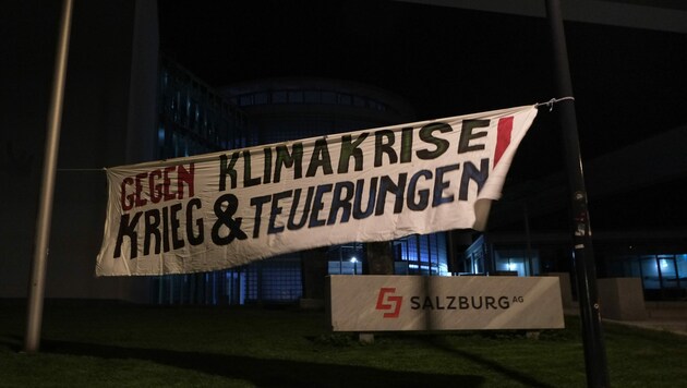 Die Aktivisten hissten ein Transparent vor dem Gebäude der Salzburg AG (Bild: Erde Brennt)
