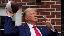 Donald Trump wirft einen Football in die Menge während eines Besuchs eines College-Footballspiels. Nebenbei will er auch die zuständige Richtern aus dem Prozess gegen ihn kicken. (Bild: The Associated Press)