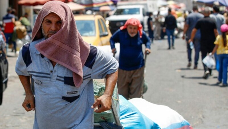 Irakische Arbeiter im Zentrum von Bagdad (Bild: AFP)