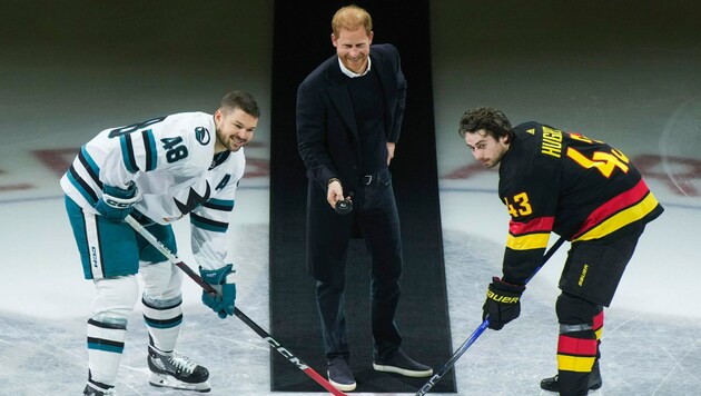 Prinz Harry (Mitte), soll den Puck zwischen Thomas Hertl von den San Jose Sharks (links) und ...