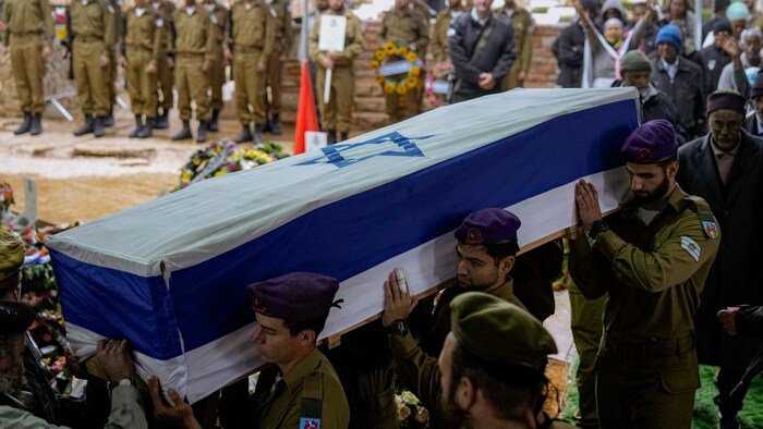 Israelische Soldaten tragen einen mit der israelischen Flagge geschmückten Sarg zu Grabe.