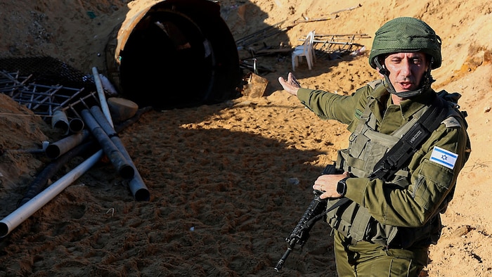Army spokesman Daniel Hagari in front of a tunnel entrance