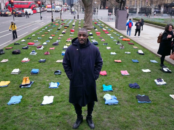 Idris Elba steht in London am Parliament Square zwischen zusammengelegten Kleidungsstücken, die die vielen Messer-Opfer in Großbritannien repräsentieren sollen.