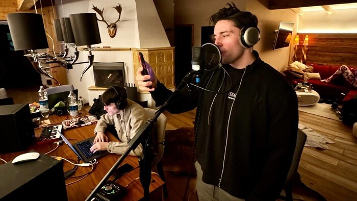 The singer singing one of his new songs in the rented house.