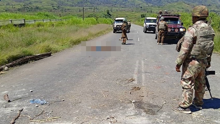 Photos show stripped and bloodied corpses by the roadside.
