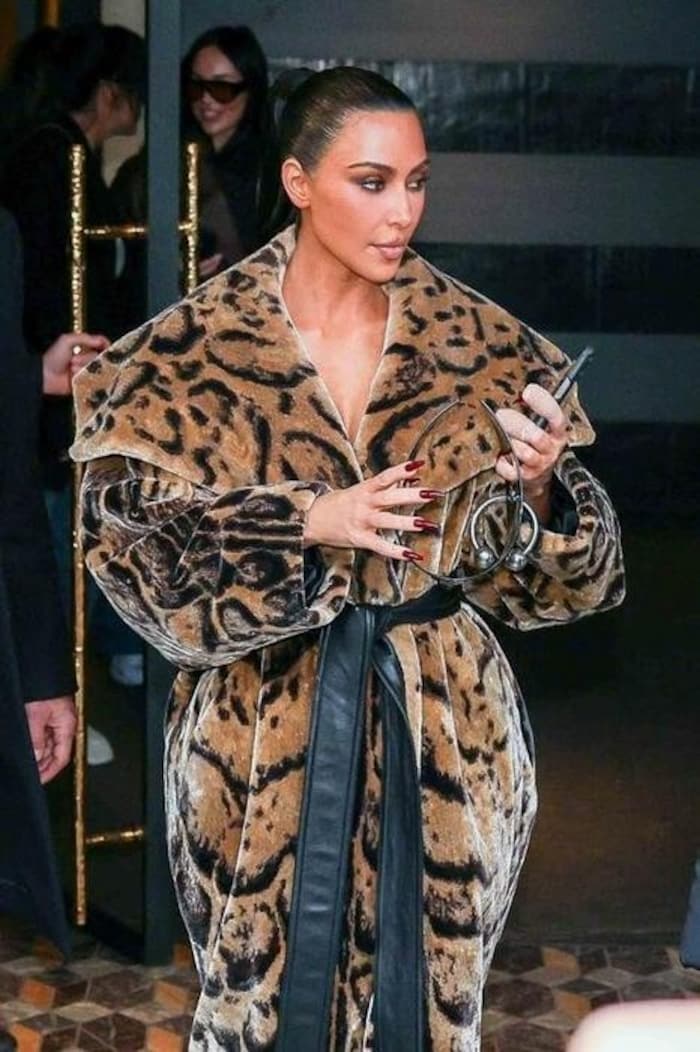 The reality starlet paired it with red nails and a sleek plait.