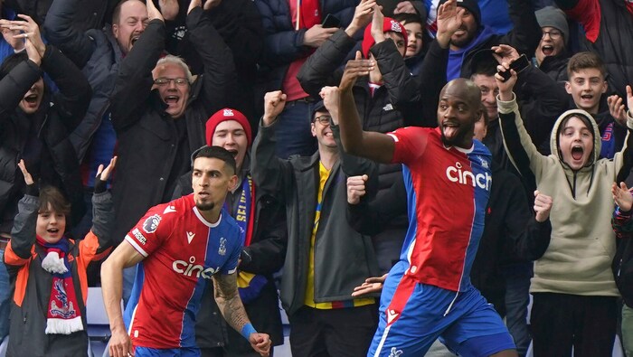 Jean-Philippe Mateta (right) celebrates a goal in a Palace shirt.