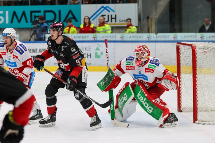 The KAC defense around goalie Dahm (right) withstood every onslaught.