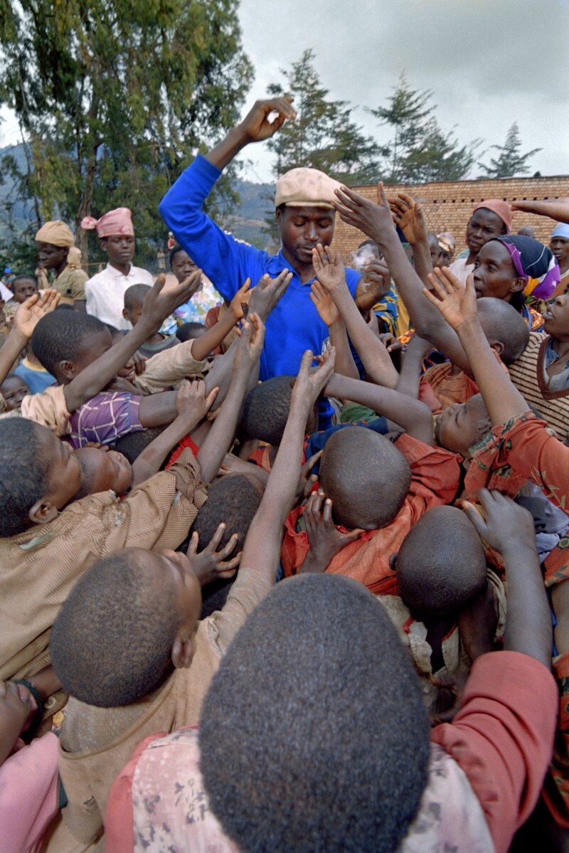 Ein Mann in Ruanda verteilt Essen an hungrige Kinder. (Bild: AFP)