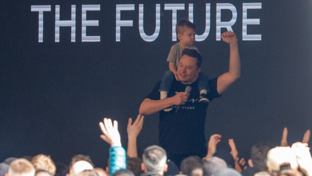 Elon Musk pronunció su discurso ante los trabajadores con uno de sus hijos a hombros. (Bild: APA/dpa/Carsten Koall)
