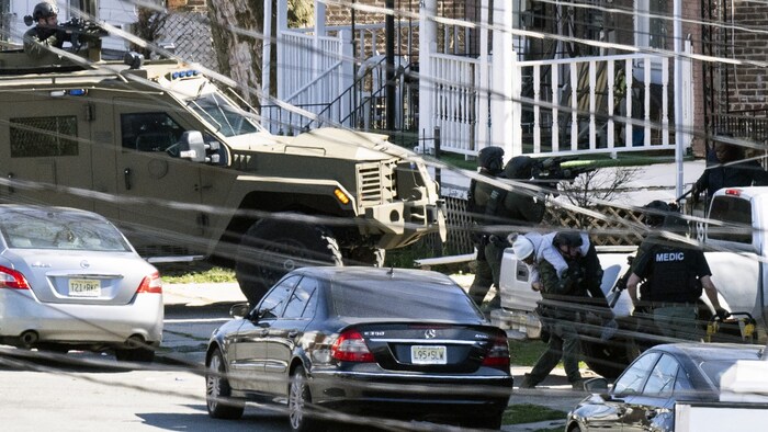 The building in which the shooter had barricaded himself with several hostages was surrounded by ...