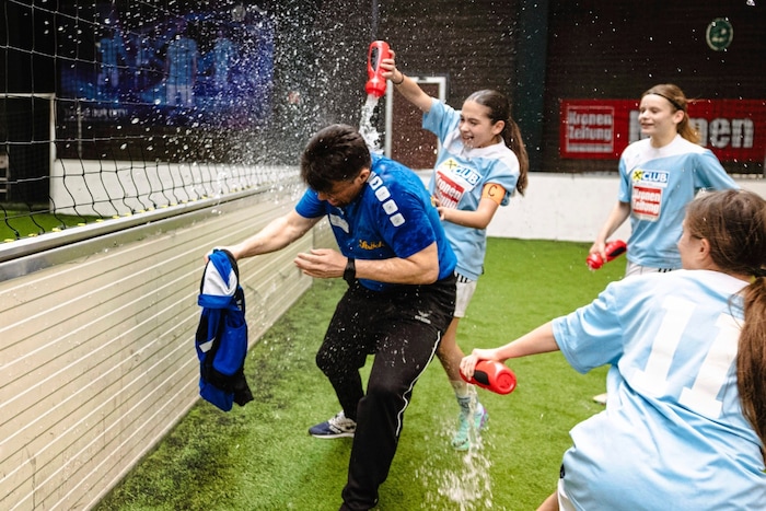The Polgar girls showered coach Karlheinz Piringer with water