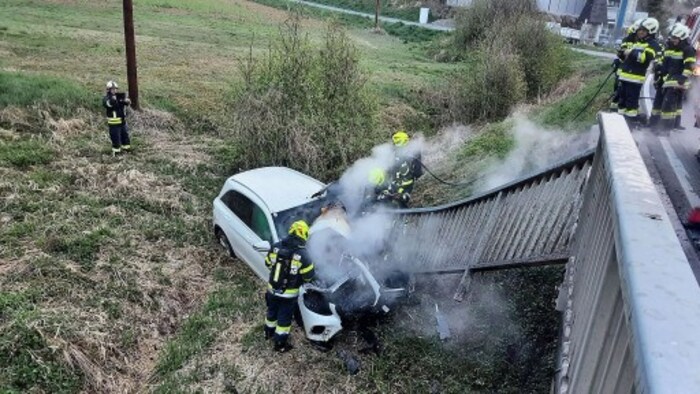 The woman survived the fall and was rescued from the flames.