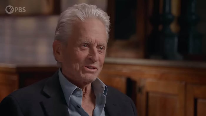 Michael Douglas learns from presenter Henry Louis Gates that Johansson is his "DNA cousin".