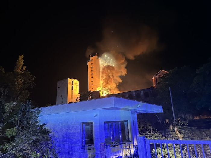 A high column of smoke stood over the burning building.