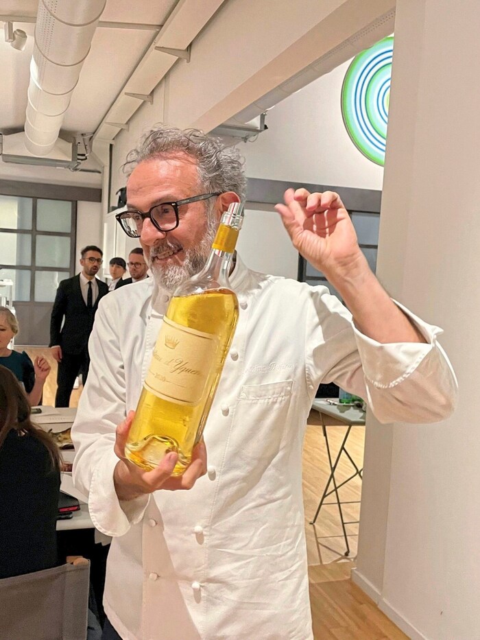 Massimo Bottura pours out ice-cold sweet wine in the restaurant.