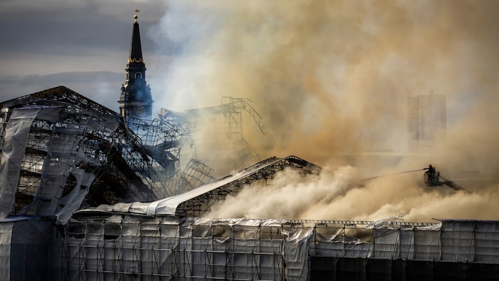 Smoke still rises above the badly damaged building after the blaze.