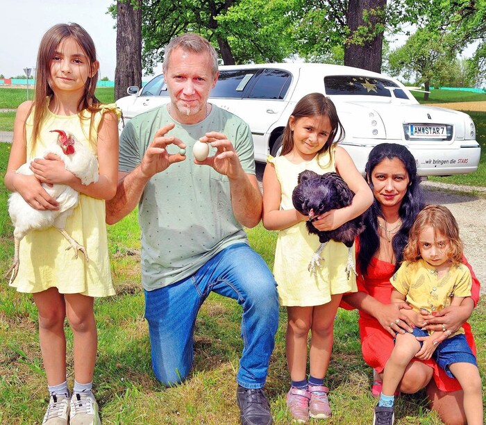 Andreas Ströbitzer with girlfriend Claudia Rezes, son Brayen and daughters Loreen and Leonie - holding the two hens that laid the special eggs.