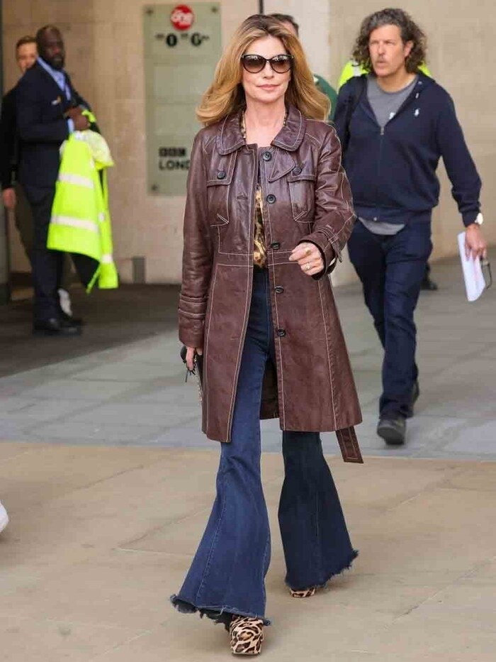 Shania Twain in casual animal print style with leather coat