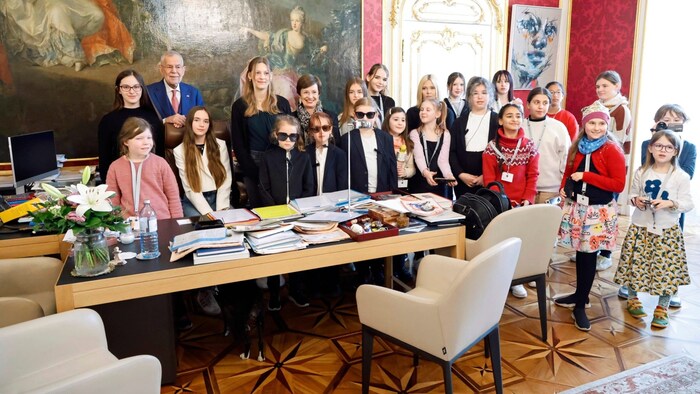 The invited guests around the President's desk
