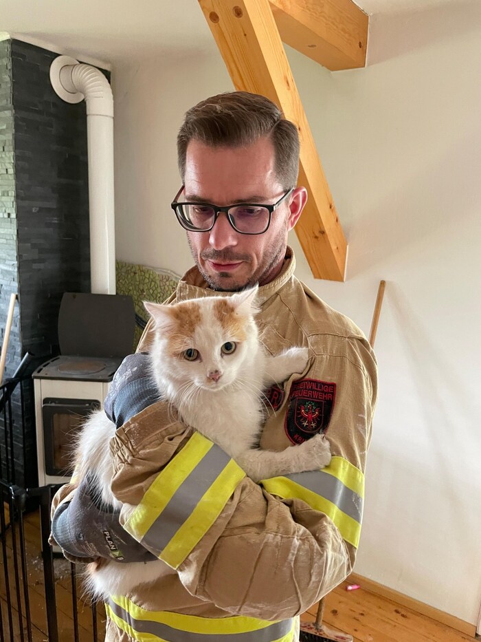 Commander Rene Arzberger with the visibly stressed ball of fur.