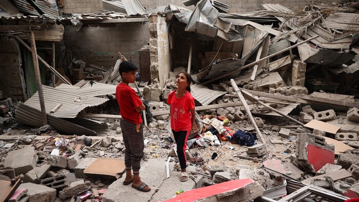 Kinder stehen nach einem nächtlichen Angriff auf Rafah im Süden des Gazastreifens zwischen ...