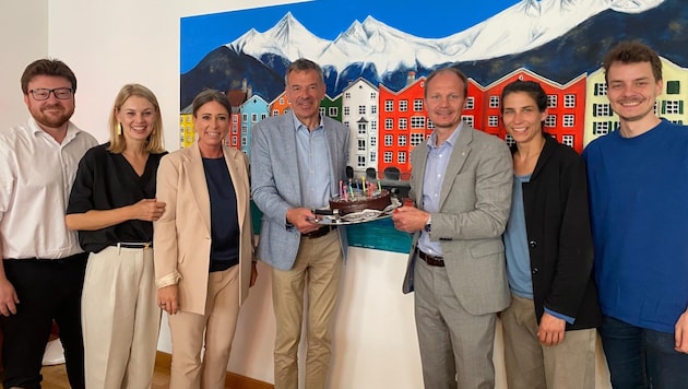 Mayor-designate Johannes Anzengruber (3rd from right) presented a birthday cake to Georg Willi (center), who is still the incumbent mayor. (Bild: JA – Jetzt Innsbruck)