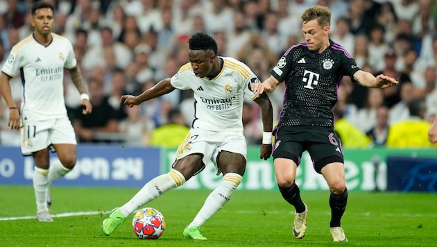 Vinicius Junior (Mitte) gegen Joshua Kimmich (rechts) war eines der Schlüsselduelle der Partie. (Bild: AP ( via APA) Austria Presse Agentur/ASSOCIATED PRESS)