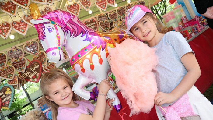 Children's faces light up with candy floss.