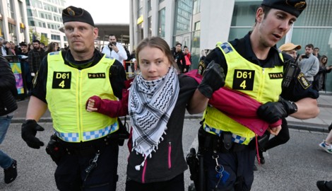 Greta Thunberg wird am Samstagabend von der schwedischen Polizei abgeführt. Sie trägt ein Palästinensertuch. (Bild: APA Pool/APA/AFP/TT NEWS AGENCY/Johan NILSSON)