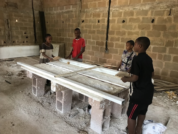 Erfinderische Kinder spielen mit den Materialien Tischtennis