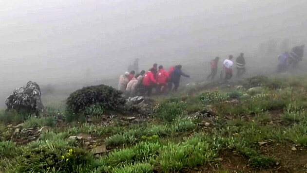 The Iranian Red Crescent has declared the search for the victims of the helicopter crash to be over and has also published pictures of the recovery of the bodies. (Bild: APA/AFP/Iranian Red Crescent)