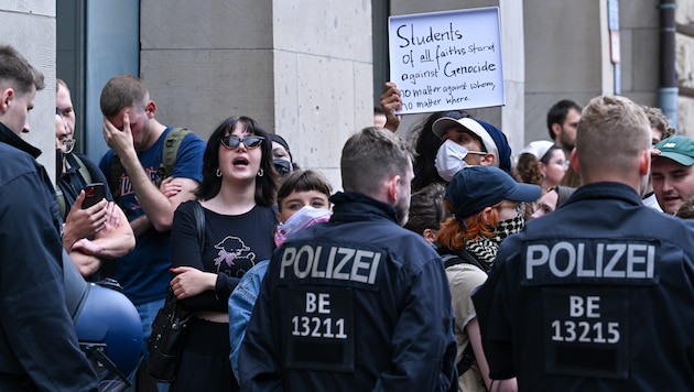 Pro-Palestinian demonstrators stand behind a police cordon in front of the Institute for Social Sciences at Humboldt University (Bild: APA/dpa/Soeren Stache)
