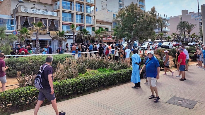 Holidaymakers take a look at the scene of the accident.