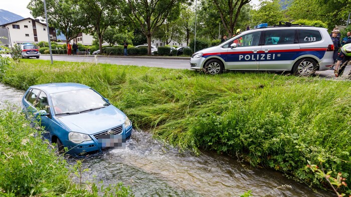 The getaway car ended up in the bed of a stream.
