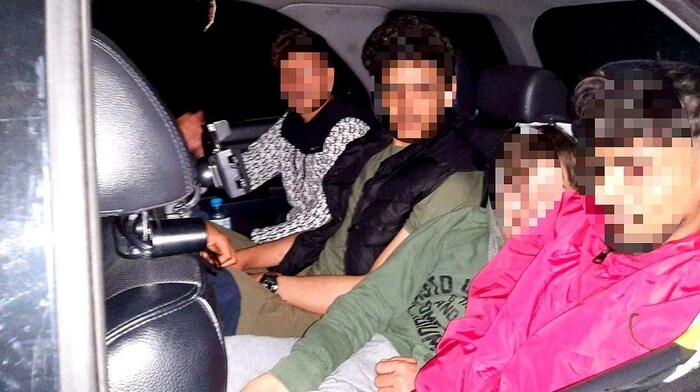 Four men and boys shared the back seat of the car.