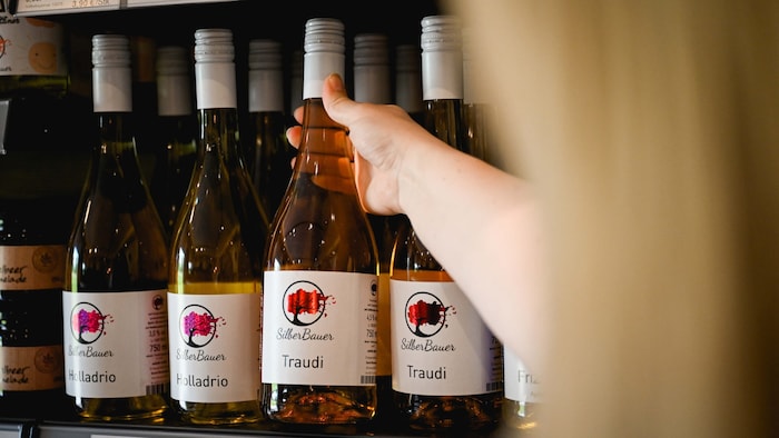 The young couple sell their own juices in the farm store.