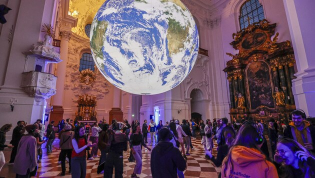 Under the "Gaia" globe installation, the Kollegienkirche was transformed into a dance floor for ...