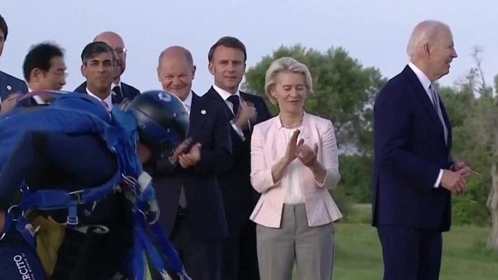 US President Joe Biden (right) moves away from the other participants at the G7 summit.
