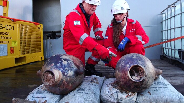 Hundreds of intact amphorae have been discovered on the seabed off the coast of Israel (two recovered specimens in the picture).