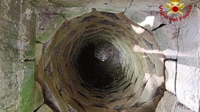 The well is around 15 meters deep and was half full of water.