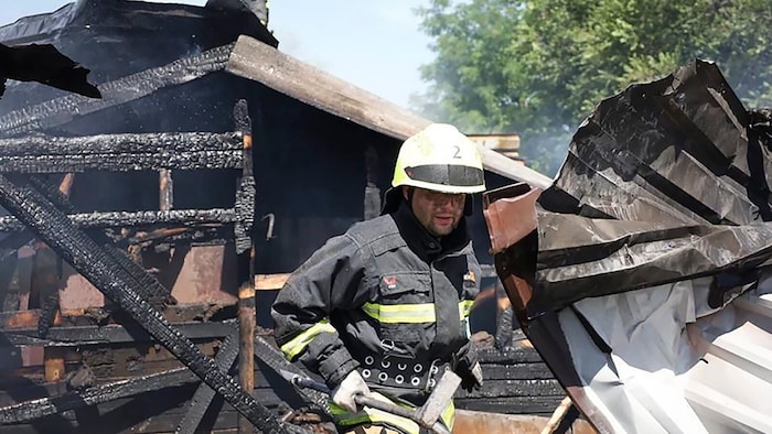 Emergency worker in the rubble of a house