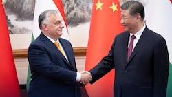 Ungarns Präsident Viktor Orban (links) schüttelt dem chinesischen Präsidenten Xi Jinping (rechts) in Peking die Hand. (Bild: APA/AFP/X ACCOUNT OF HUNGARY‘S PRIME)