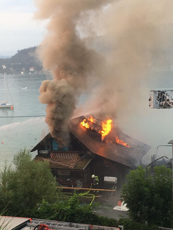 The flames from the burning boat spread to the lake house.