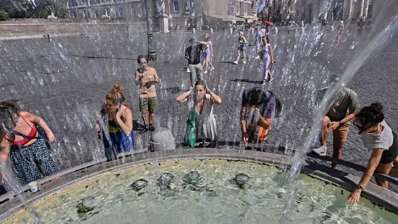 Menschen kühlen sich am Löwenbrunnen in Rom ab. (Bild: AFP/Andreas Solaro)